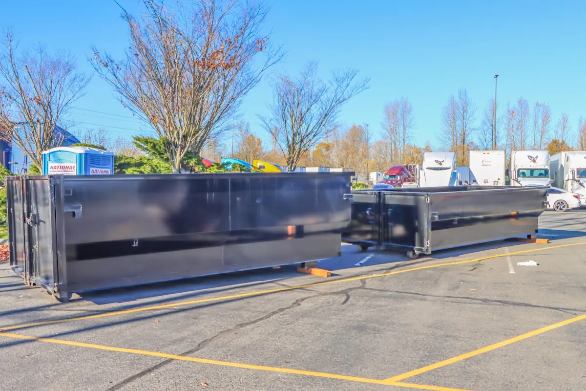 Professional dumpster rental service with roll-off container on residential driveway in North Port
